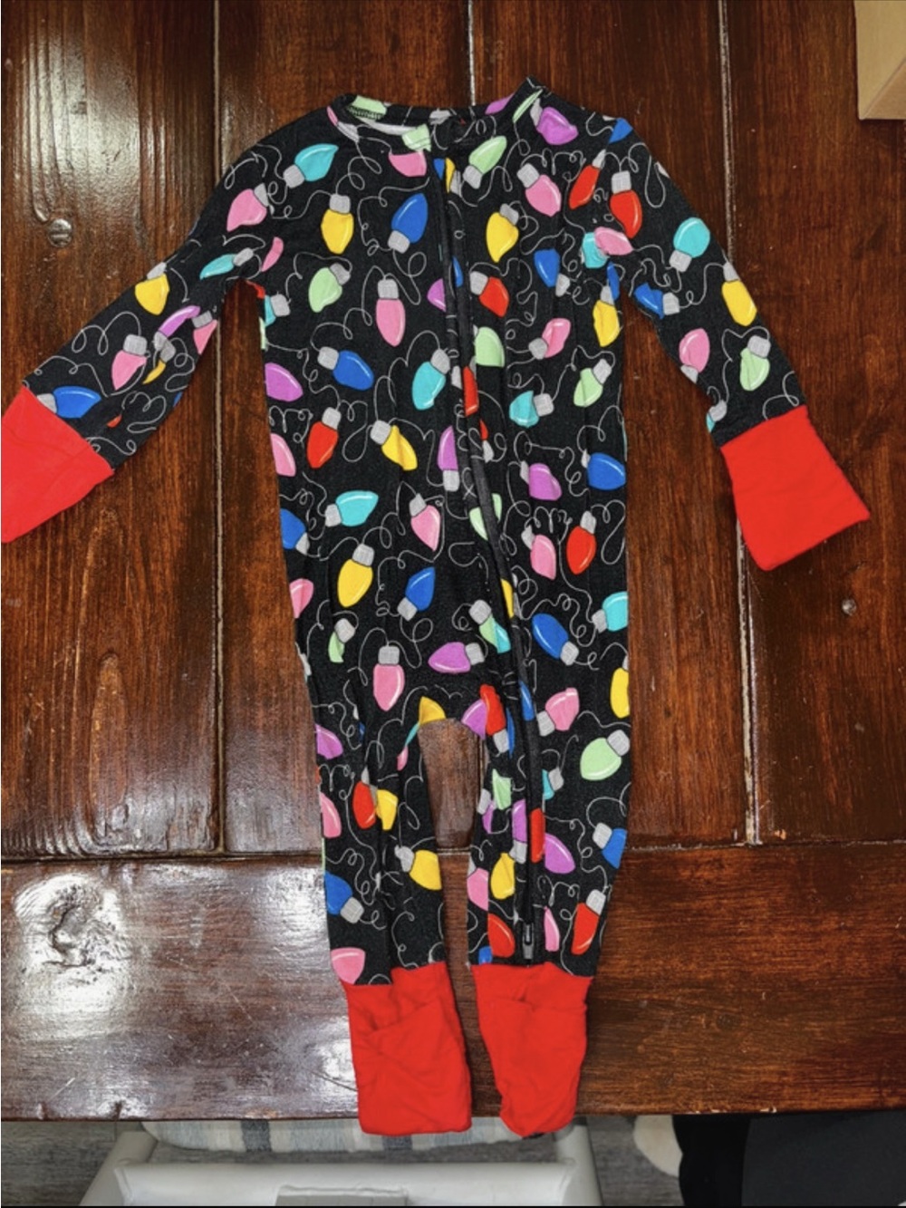 Kids Black Holiday Light Print Footed One-Piece Pajamas with Red Cuffs